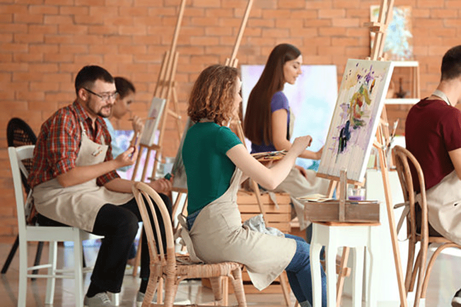 Students with easels in an adult art class