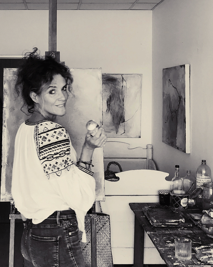 Artist Molly Gaisford painting in her studio